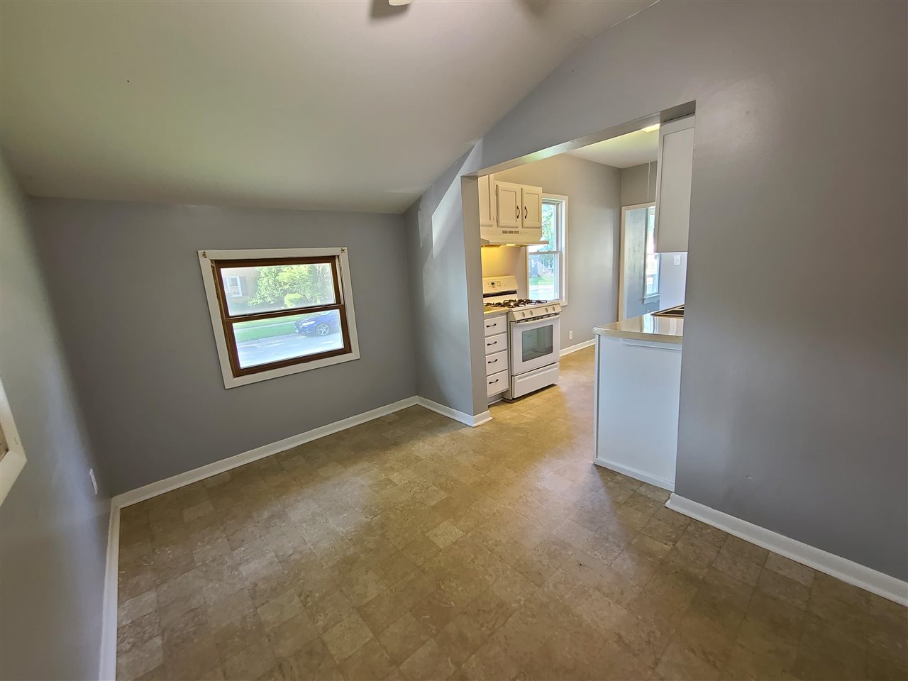 528 North 12th Street Rochelle, IL 61068 - Photo 5 of 16 an empty room with windows and entrance to other room