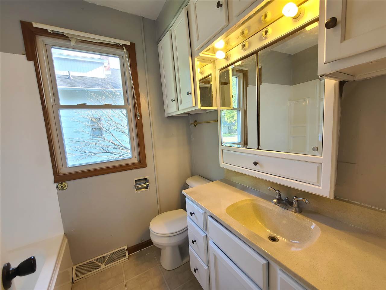 528 North 12th Street Rochelle, IL 61068 - Photo 9 of 16 a bathroom with a granite countertop sink mirror vanity and toilet