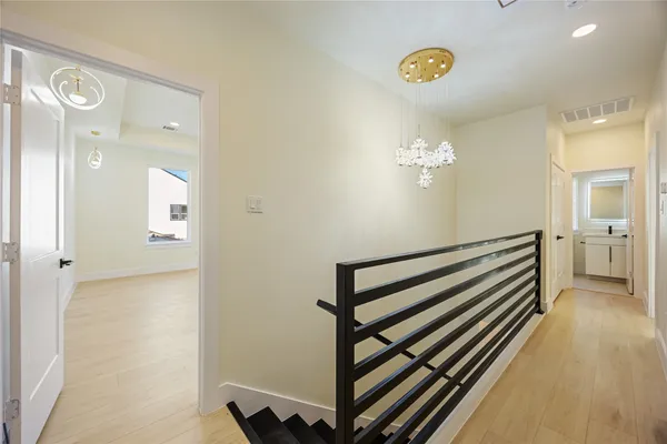 a view of a hallway with entryway wooden floor and front door