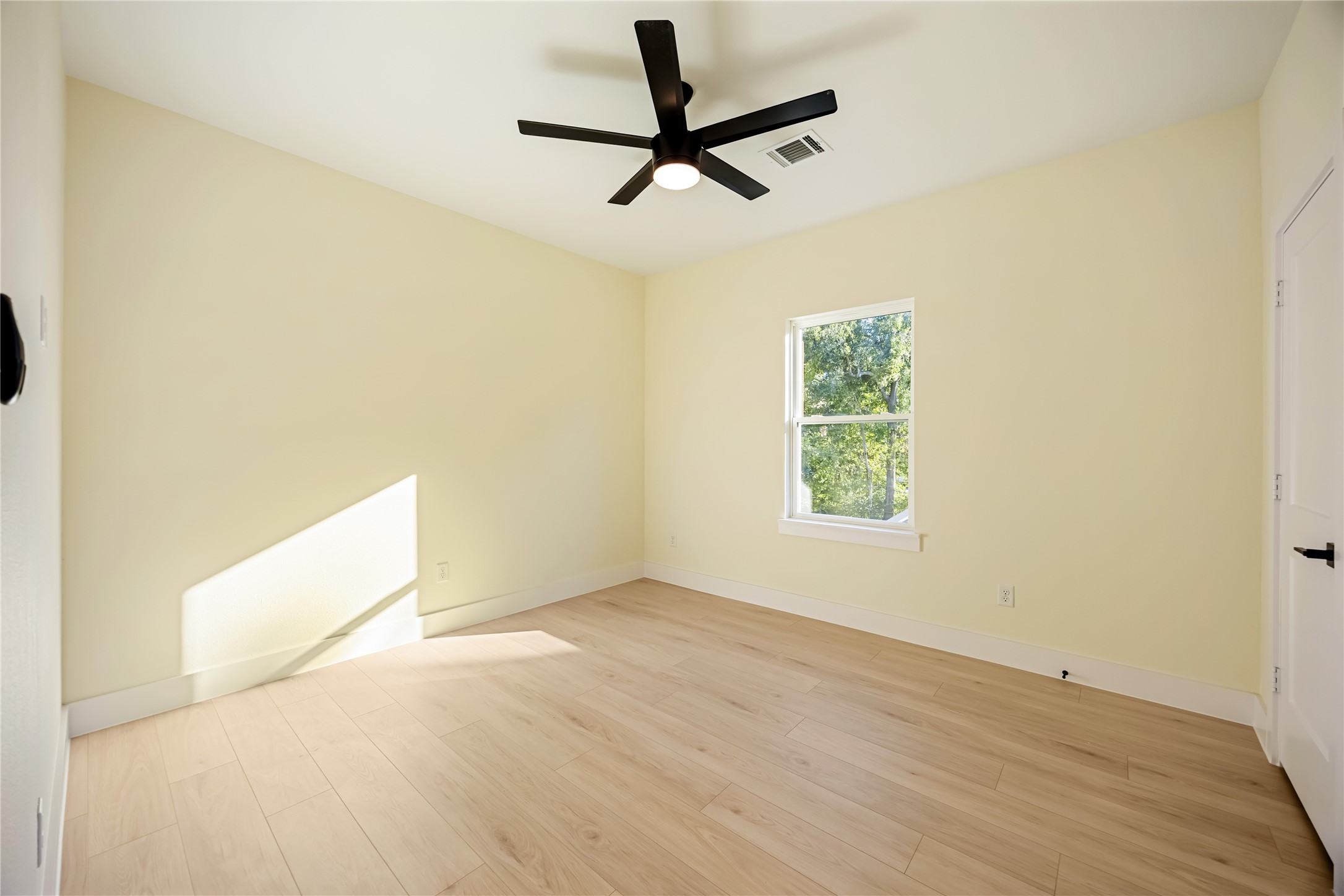 7125 England Street Houston, TX 77021 - Photo 15 of 28 a view of room with a ceiling fan and wooden floor