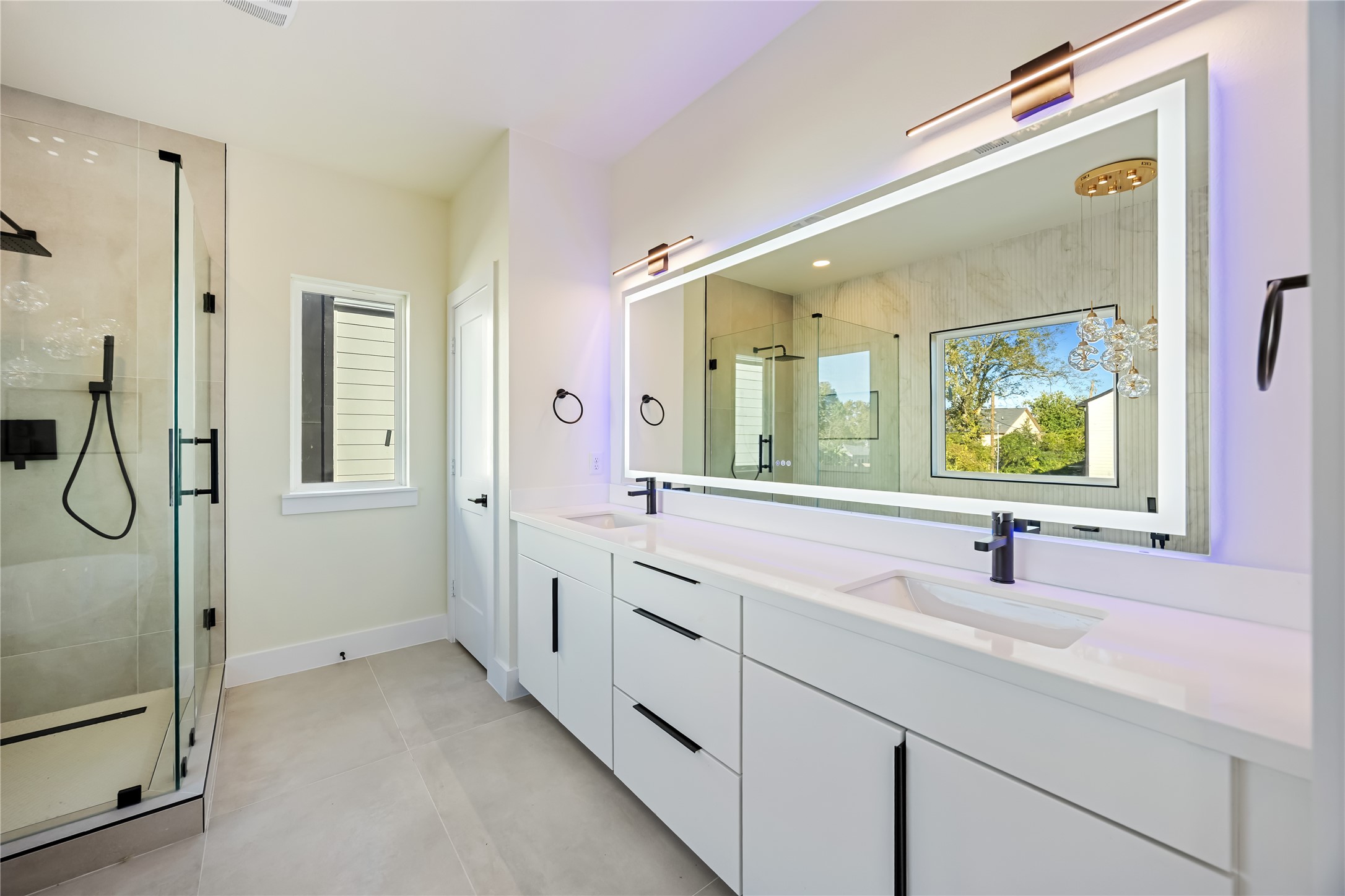 7125 England Street Houston, TX 77021 - Photo 22 of 28 a bathroom with a double vanity sink a mirror and shower