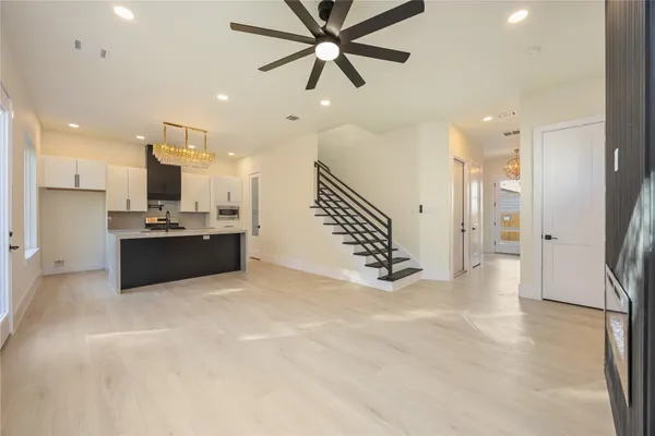 a view of kitchen and kitchen with stainless steel appliances wooden floor