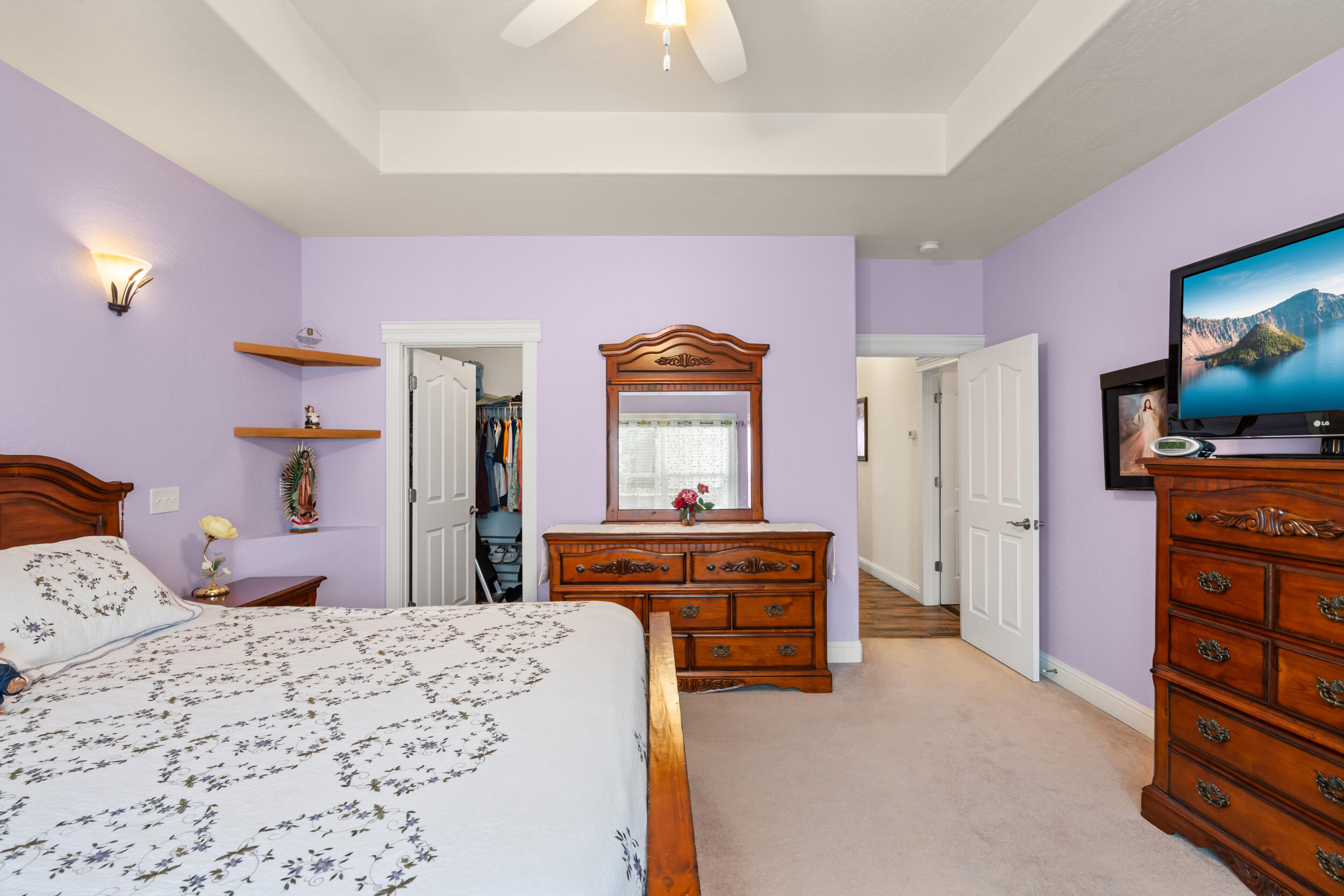 1227 Lithia Way Talent, OR 97540 - Photo 16 of 37 a bedroom with a bed and a flat tv screen on dresser