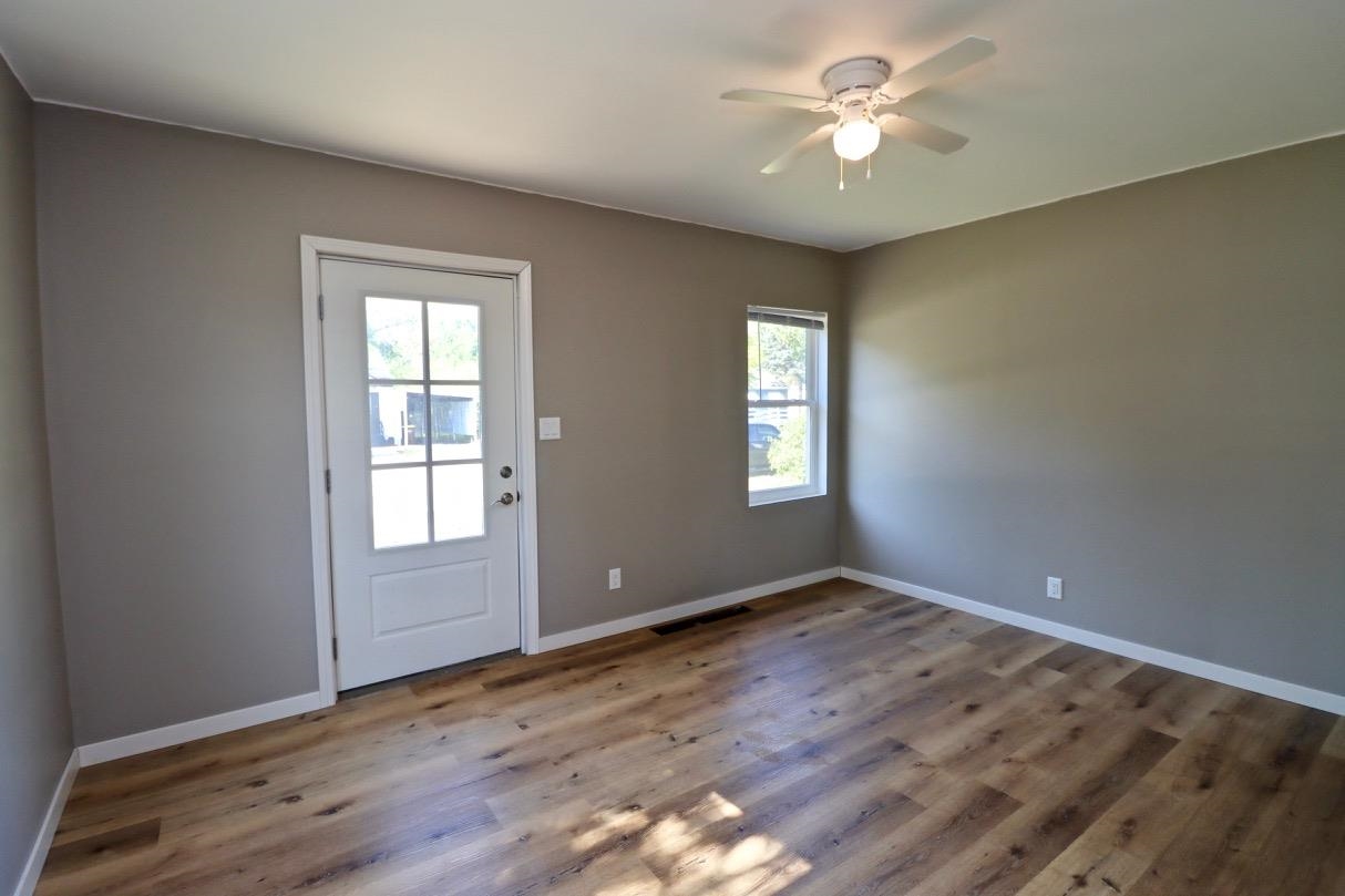 2228 Magnolia Rockford, IL 61104 - Photo 2 of 8 a view of an empty room with window and wooden floor