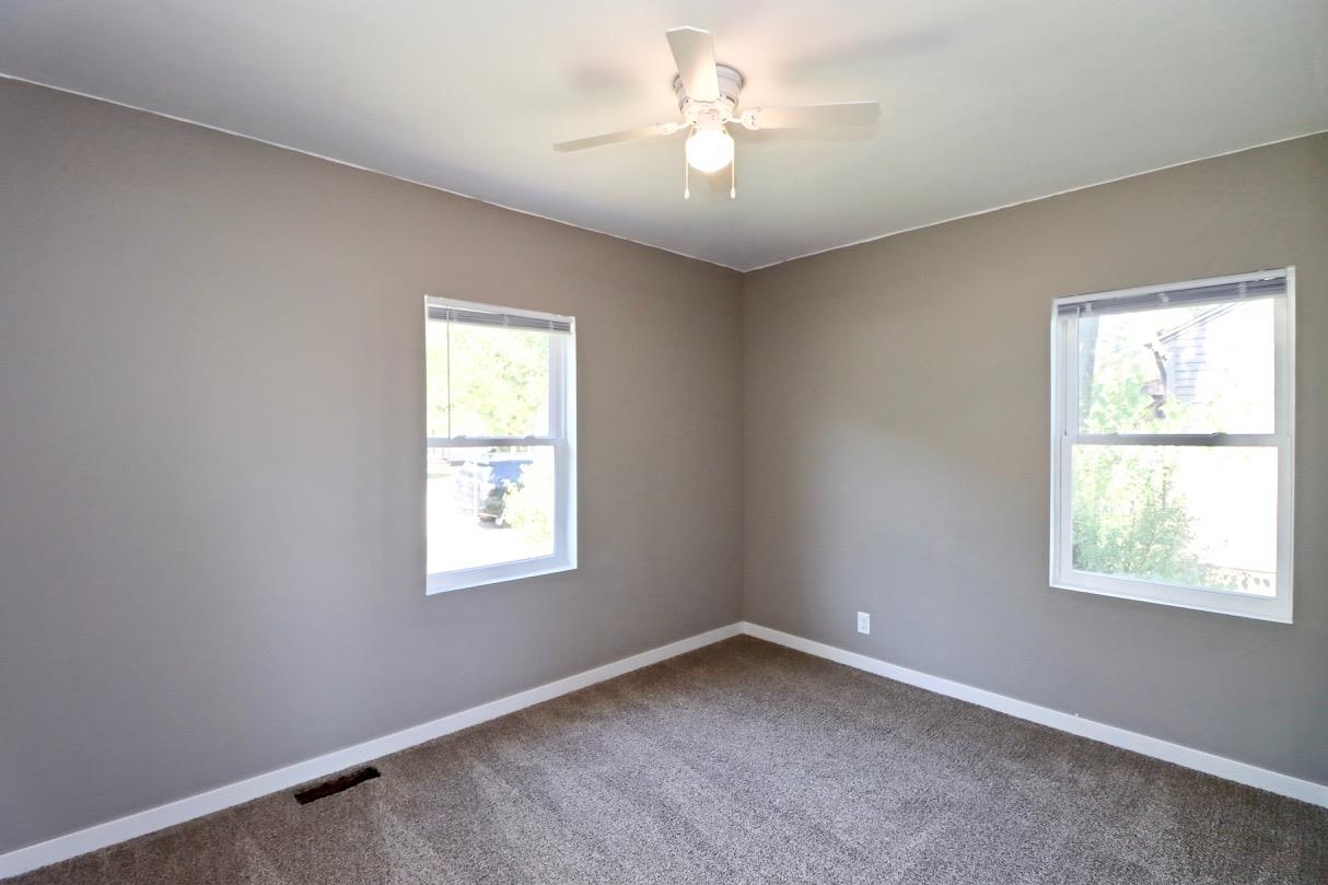 2228 Magnolia Rockford, IL 61104 - Photo 3 of 8 an empty room with a window and a fan
