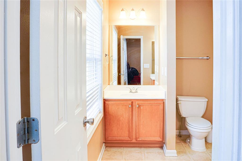 7071 Galloway Point Riverdale, GA 30296 - Photo 12 of 22 a bathroom with a toilet a sink and a window