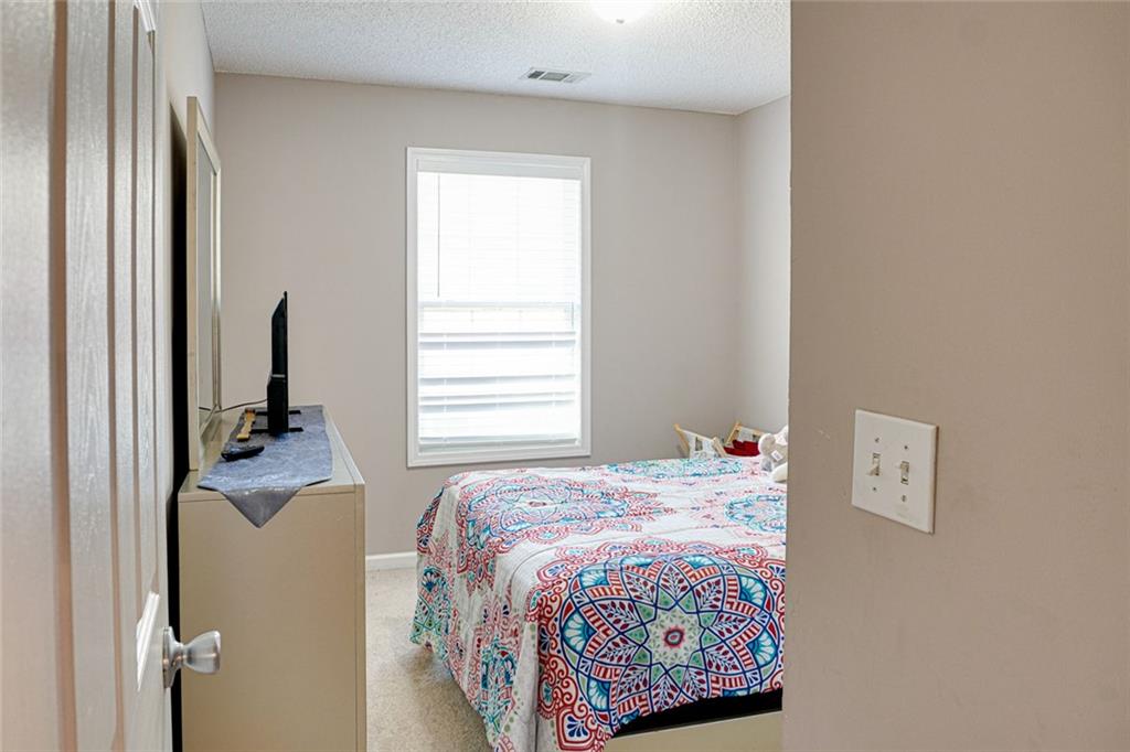 7071 Galloway Point Riverdale, GA 30296 - Photo 15 of 22 a bedroom with a bed and a window