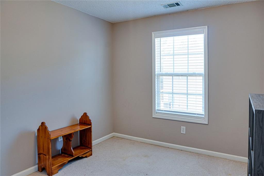 7071 Galloway Point Riverdale, GA 30296 - Photo 18 of 22 an empty room with wooden floor and windows