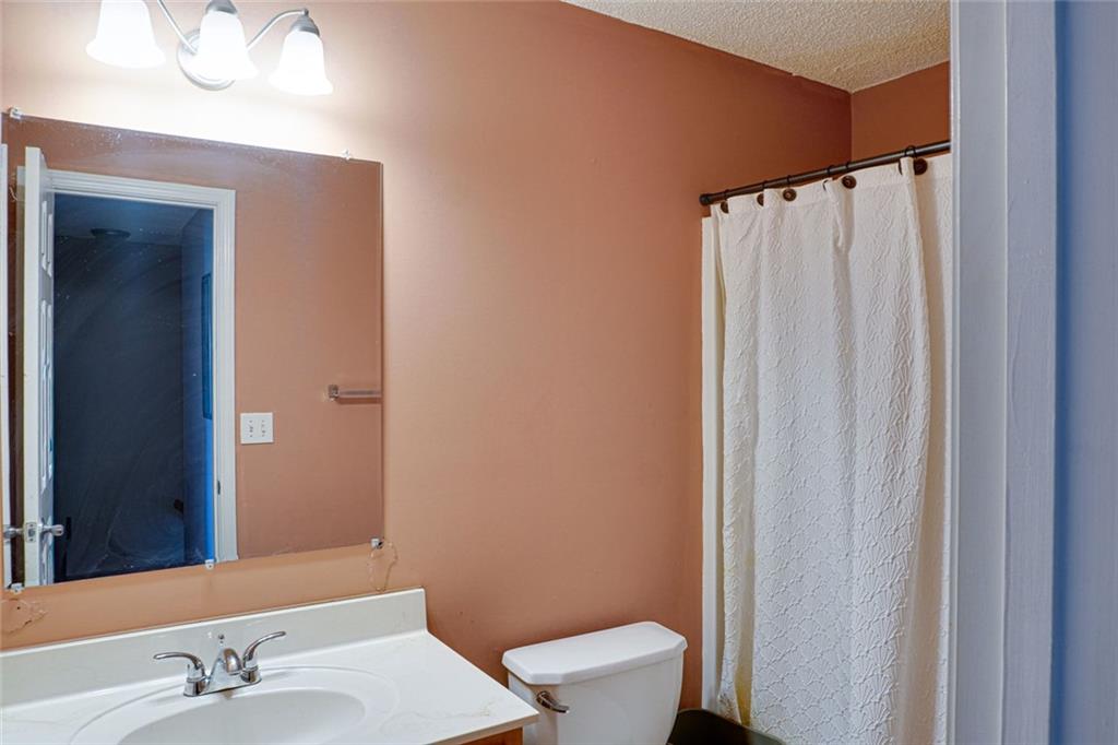 7071 Galloway Point Riverdale, GA 30296 - Photo 19 of 22 a bathroom with a sink a toilet and shower