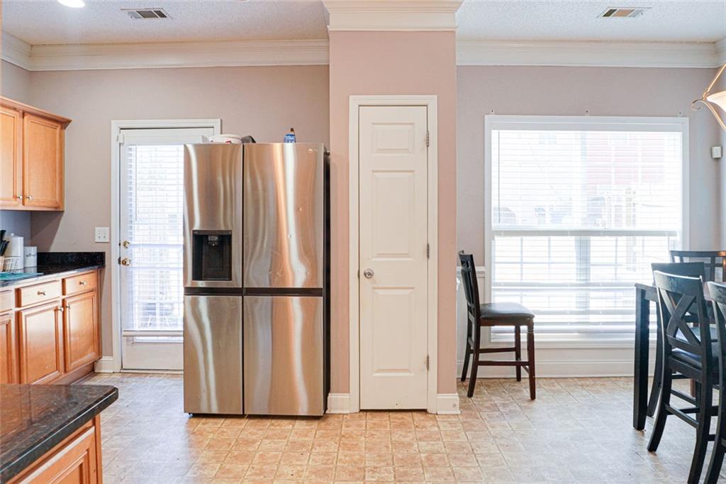 7071 Galloway Point Riverdale, GA 30296 - Photo 5 of 22 a kitchen with stainless steel appliances a refrigerator a table and chairs