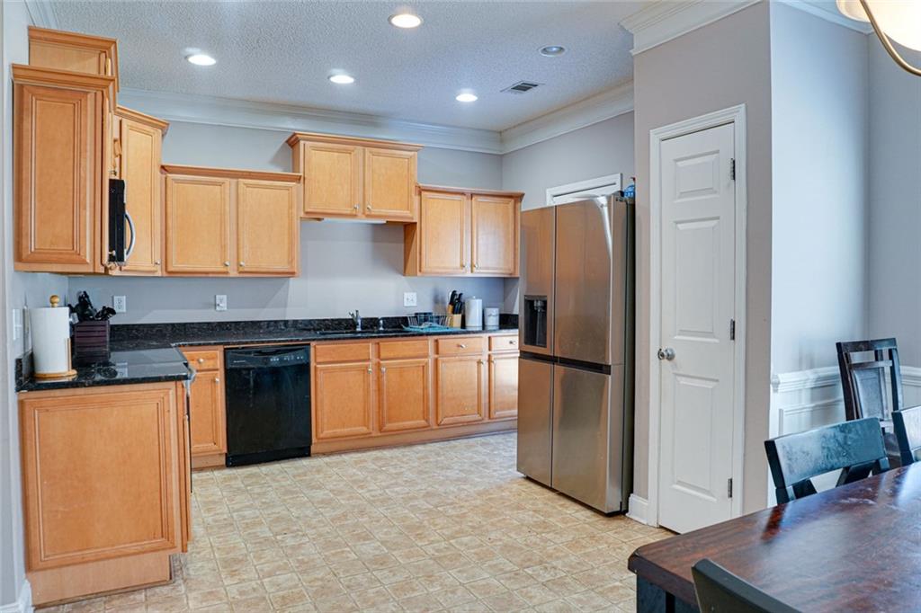7071 Galloway Point Riverdale, GA 30296 - Photo 6 of 22 a kitchen with stainless steel appliances granite countertop a refrigerator and a stove