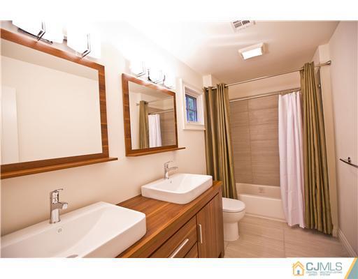 114 South Hill Road Colonia, NJ 07067 - Photo 22 of 25 a bathroom with a sink a mirror and a shower