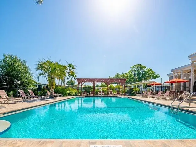 a view of an empty room with closet and wooden floor