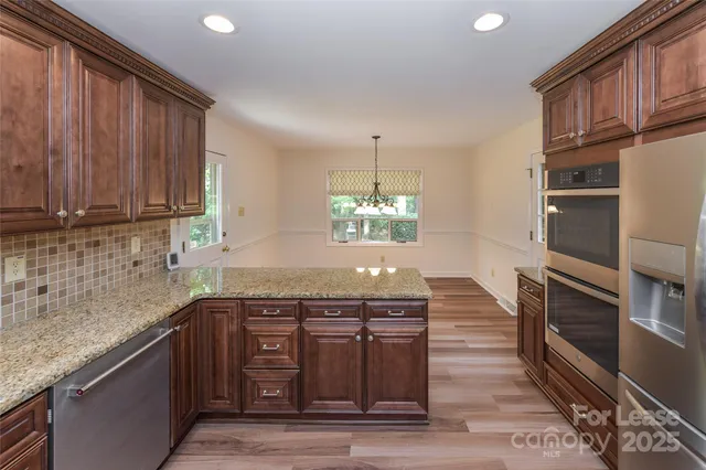 a view of a room with wooden floor and a window