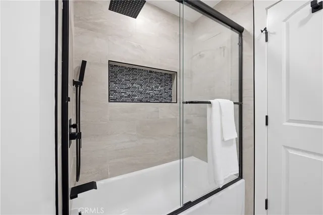 a bathroom with a shower and a glass door