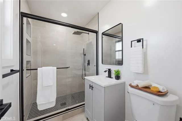 a bathroom with a sink a mirror and a shower