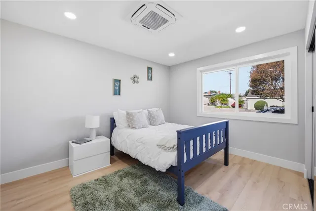 a bedroom with a bed window and a table