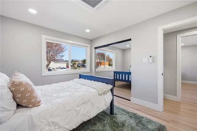 a bedroom with a large bed and a painting on the wall
