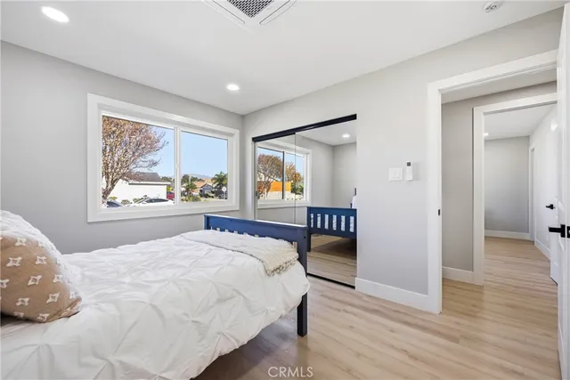 a bedroom with a large bed and a window