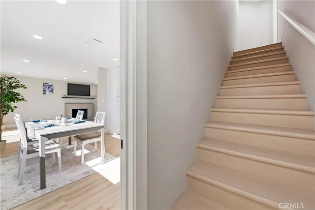 a view of entryway kitchen and hall with wooden floor