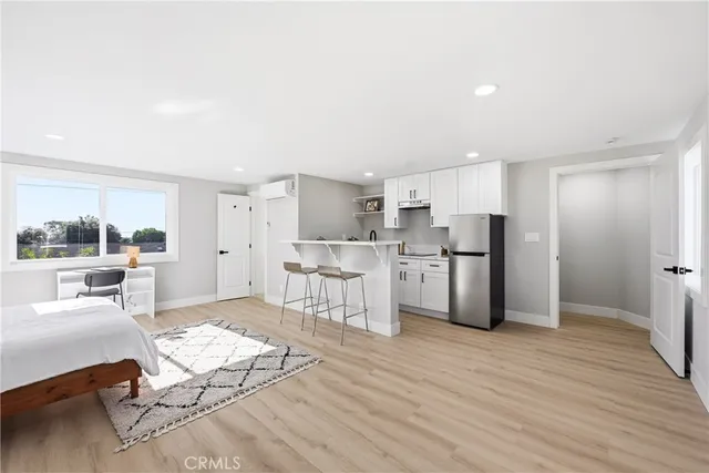 a kitchen with stainless steel appliances kitchen island granite countertop a refrigerator and a stove top oven