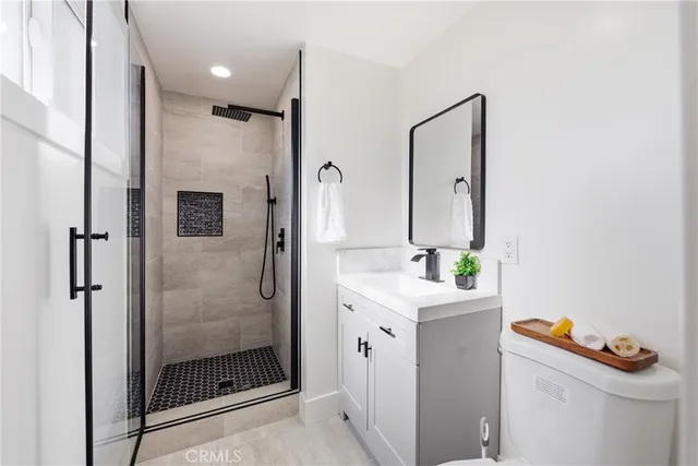 a bathroom with a shower a sink and a mirror