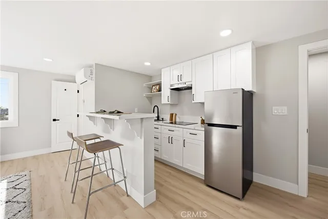 a kitchen with stainless steel appliances a refrigerator sink and cabinets