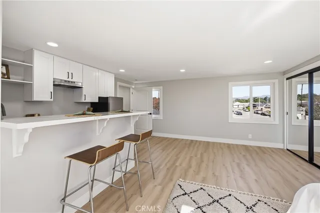 a kitchen with a sink cabinets and wooden floor