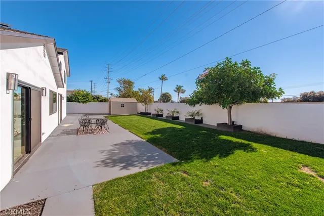 a view of a backyard with plants and outdoor seating