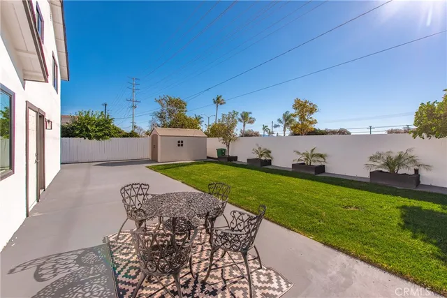 a view of a patio with table and chairs and potted plants