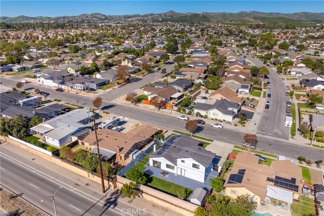 an aerial view of residential houses with city view