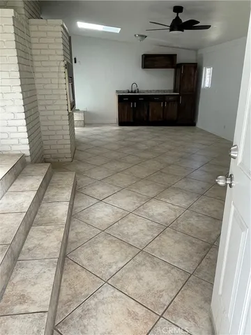 a view of a hallway with kitchen