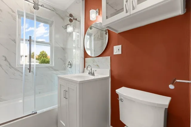 a bathroom with a sink a toilet and a mirror