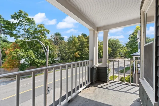 a view of a balcony with yard