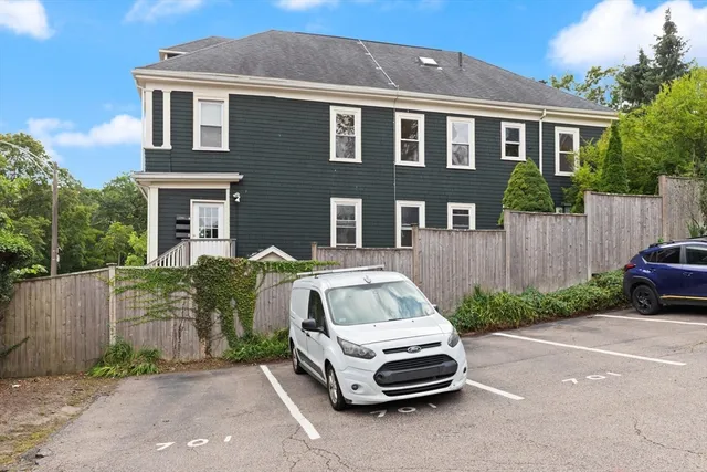 a car parked in front of a brick house