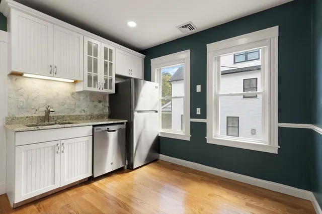 a kitchen with stainless steel appliances granite countertop a refrigerator and a stove