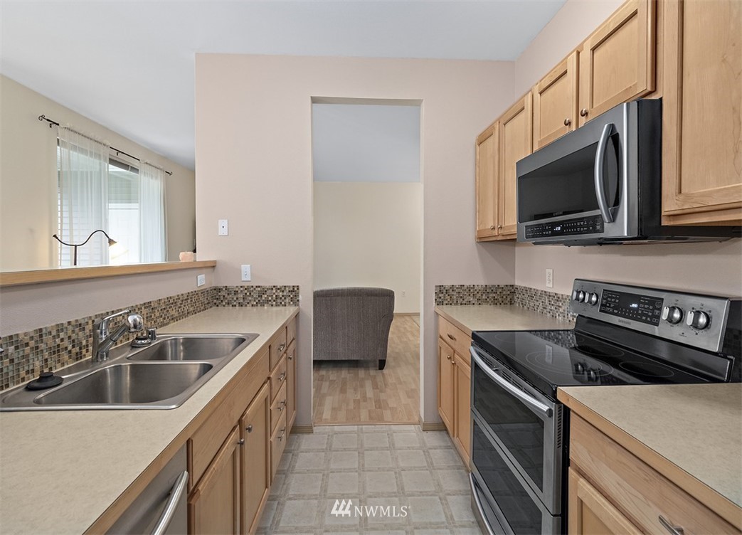 3012 Southeast 8th Place, Unit 1117 Renton, WA 98058 - Photo 13 of 40 a kitchen that has a sink and a stove