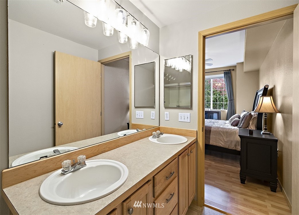 3012 Southeast 8th Place, Unit 1117 Renton, WA 98058 - Photo 17 of 40 a bath room with a sink and a mirror