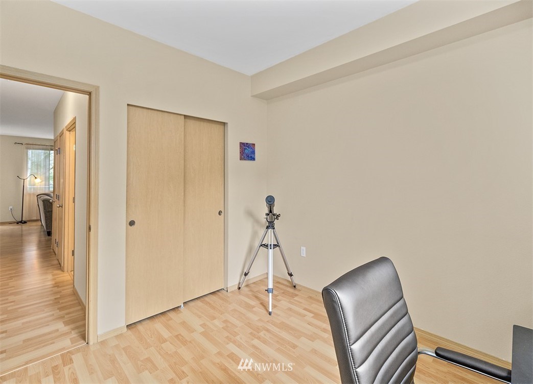 3012 Southeast 8th Place, Unit 1117 Renton, WA 98058 - Photo 21 of 40 a room with a chair and wooden floor