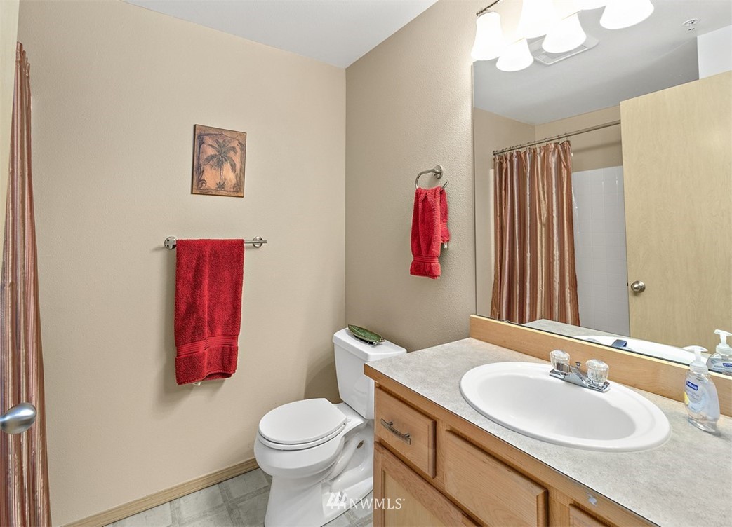3012 Southeast 8th Place, Unit 1117 Renton, WA 98058 - Photo 22 of 40 a bathroom with a sink vanity mirror and toilet