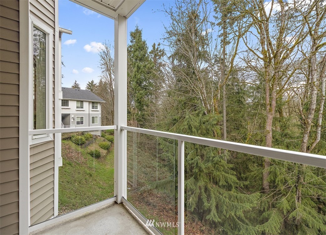 3012 Southeast 8th Place, Unit 1117 Renton, WA 98058 - Photo 26 of 40 a view of a glass door with a chair in front of balcony