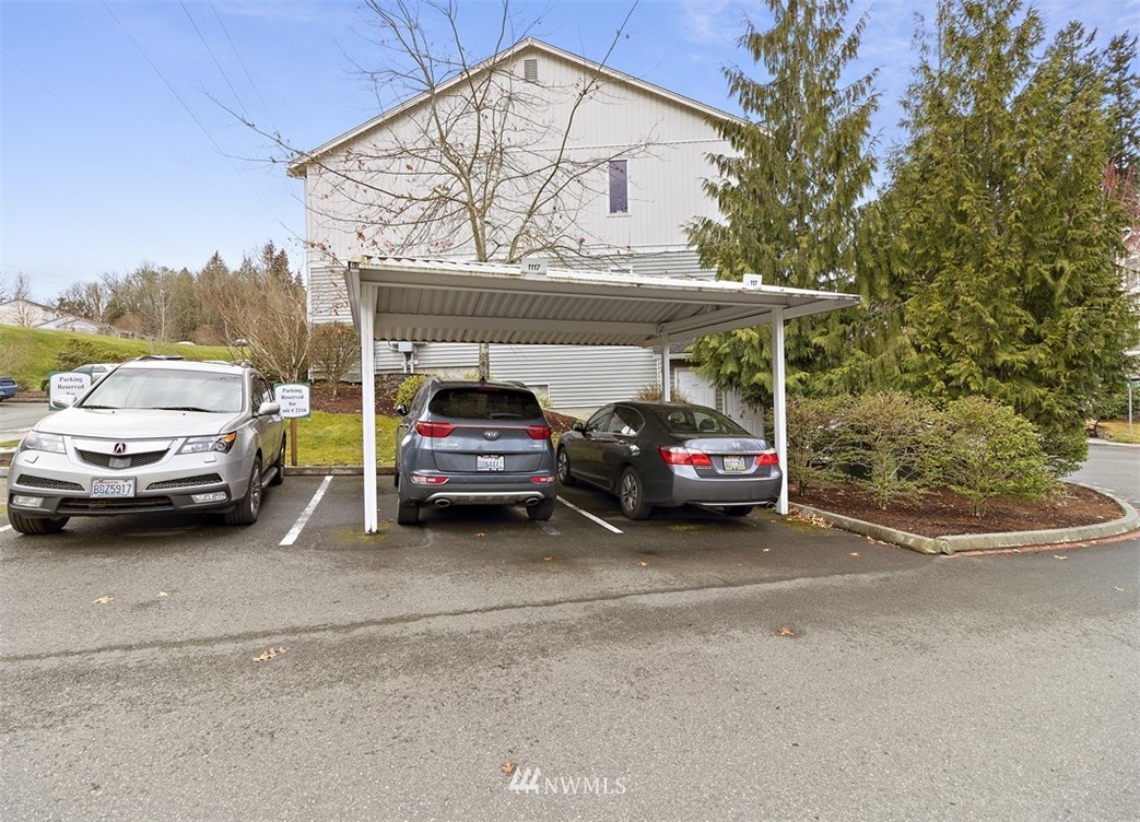 3012 Southeast 8th Place, Unit 1117 Renton, WA 98058 - Photo 28 of 40 a view of a cars parked in back of a house