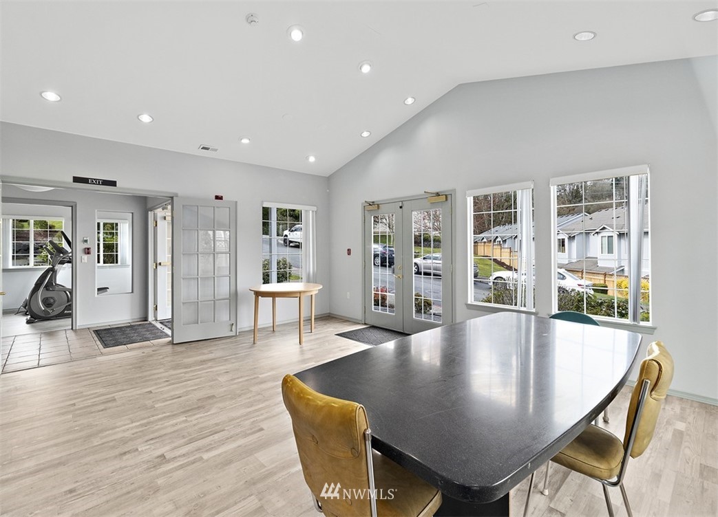 3012 Southeast 8th Place, Unit 1117 Renton, WA 98058 - Photo 32 of 40 a dining room with furniture and wooden floor