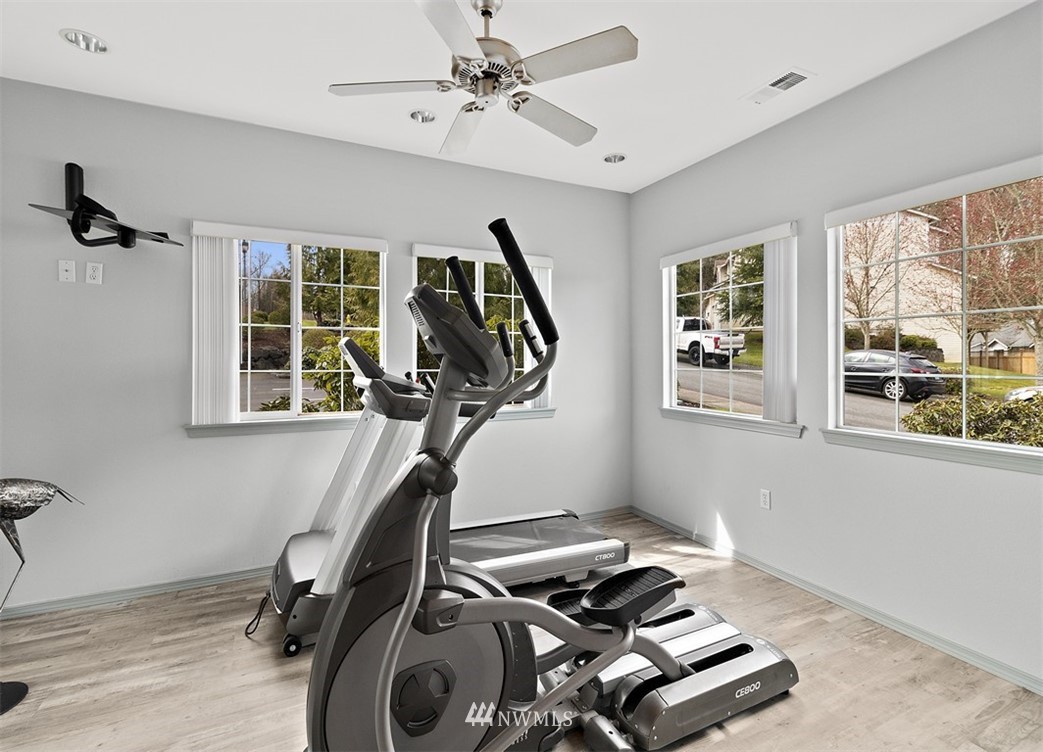 3012 Southeast 8th Place, Unit 1117 Renton, WA 98058 - Photo 33 of 40 a room with gym equipment and windows