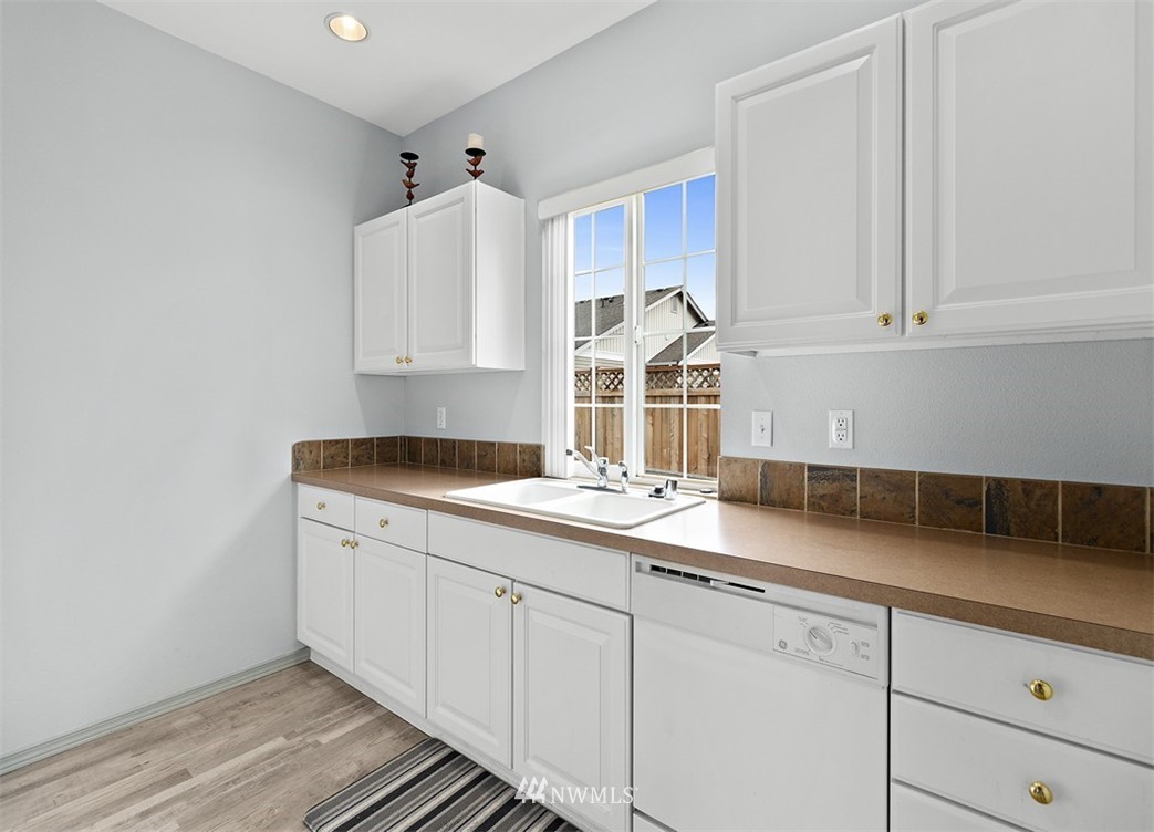 3012 Southeast 8th Place, Unit 1117 Renton, WA 98058 - Photo 37 of 40 a kitchen with a sink and cabinets