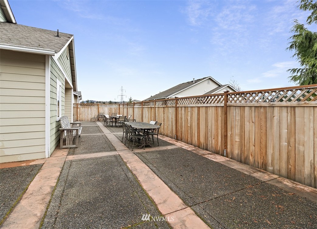 3012 Southeast 8th Place, Unit 1117 Renton, WA 98058 - Photo 38 of 40 a view of a patio with a table and chairs