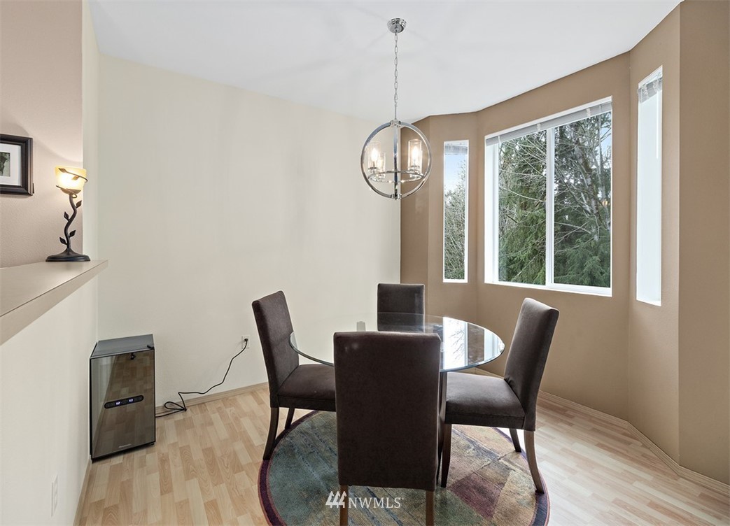 3012 Southeast 8th Place, Unit 1117 Renton, WA 98058 - Photo 8 of 40 a view of a dining room with furniture window and wooden floor