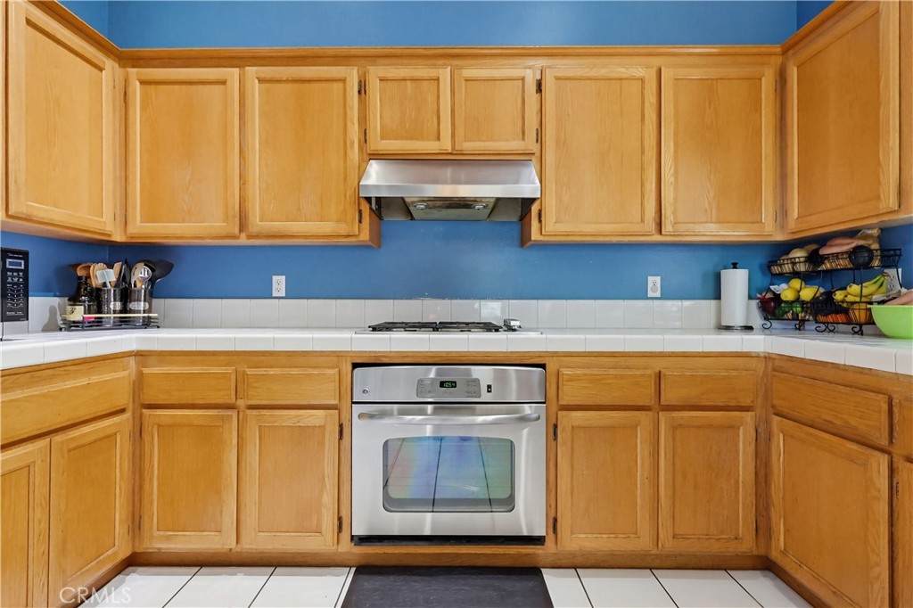 7735 Ridgeview Lane Whittier, CA 90606 - Photo 17 of 47 a kitchen with stainless steel appliances granite countertop a sink and cabinets with wooden floor