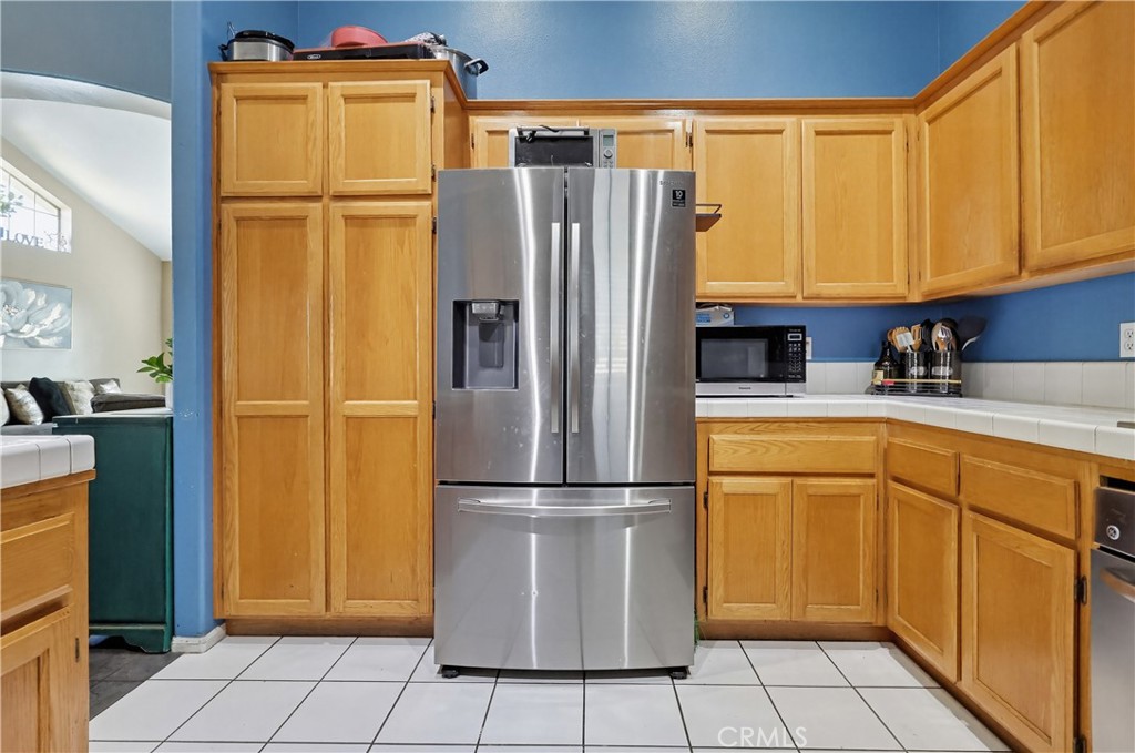 7735 Ridgeview Lane Whittier, CA 90606 - Photo 18 of 47 a kitchen with a refrigerator and cabinets