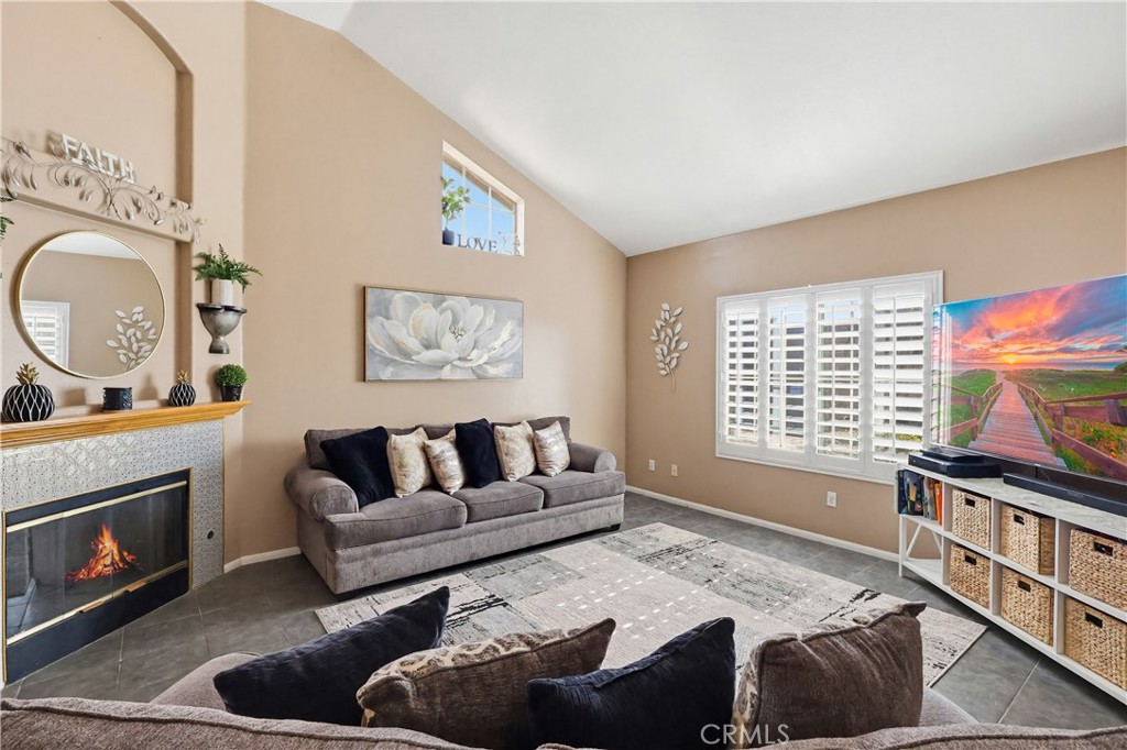 7735 Ridgeview Lane Whittier, CA 90606 - Photo 5 of 47 a living room with furniture a fireplace and a large window